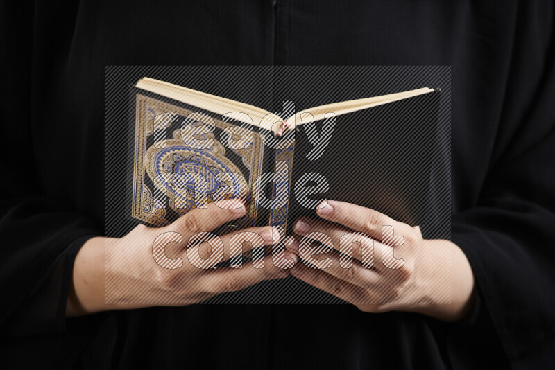 A woman hands holding moshaf in different positions