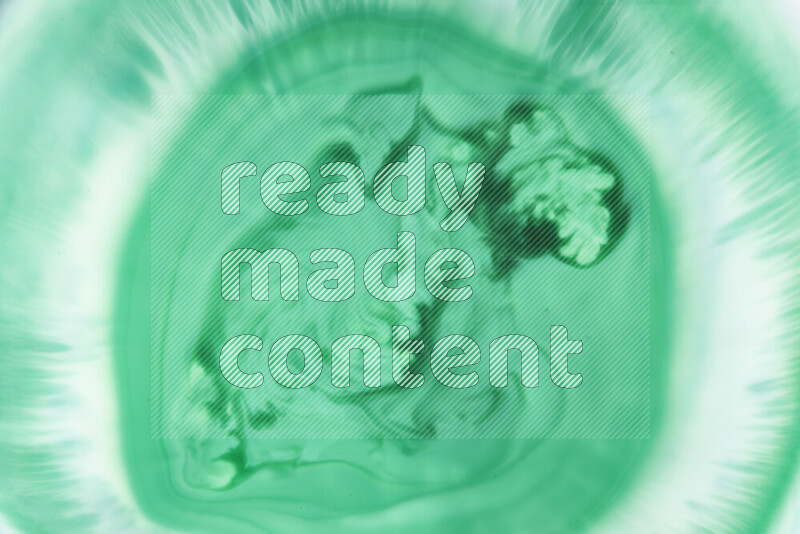 A close-up of abstract swirling patterns in green gradients