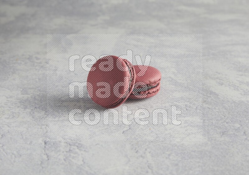 45º Shot of two Red Cherry macarons  on white  marble background