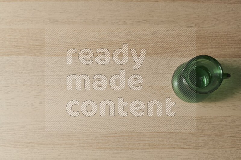 A colored glass jug on light wooden background