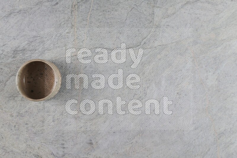 A multicolored pottery Bowl on grey marble background