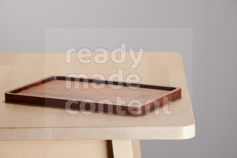 wooden trays and cutting boards on the edge of wooden table