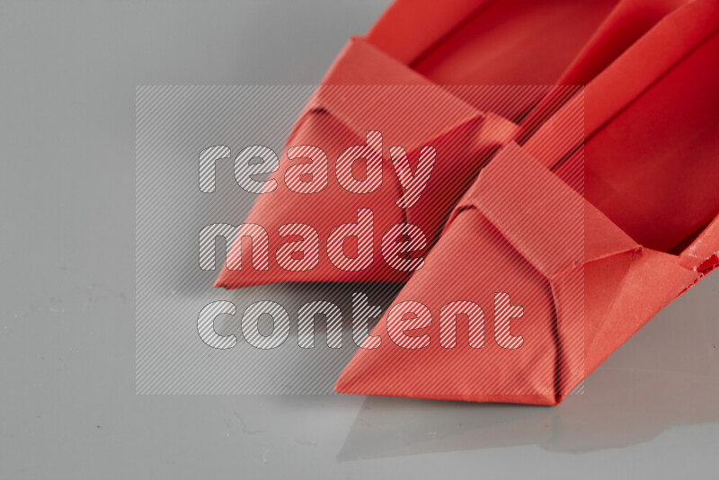 Origami shoes on grey background