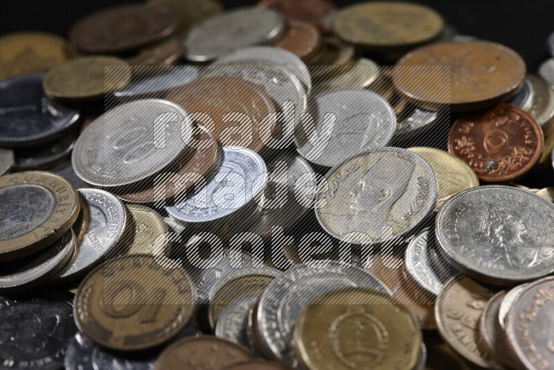 A close-ups of random old coins on black background