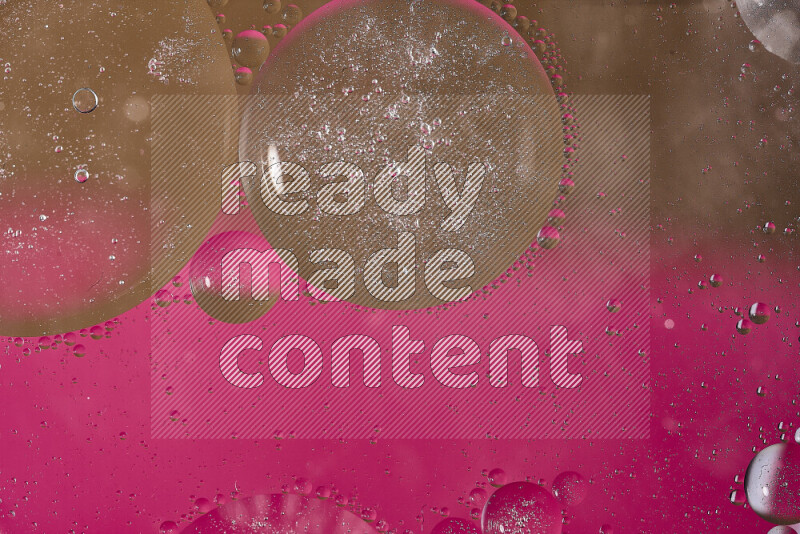 Close-ups of abstract oil bubbles on water surface in shades of pink and brown