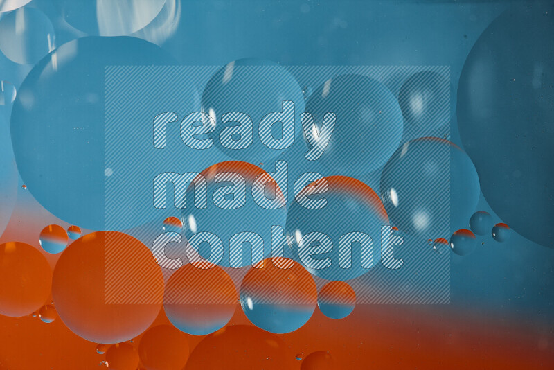 Close-ups of abstract oil bubbles on water surface in shades of blue and orange