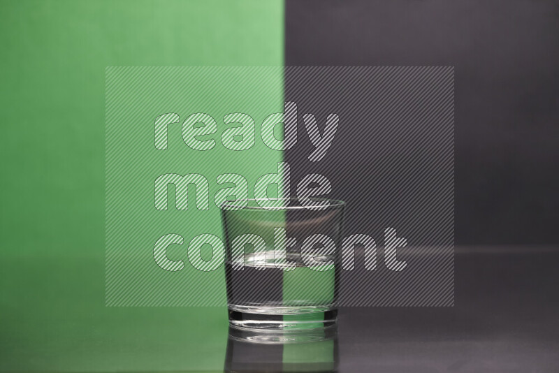 The image features a clear glassware filled with water, set against green and black background