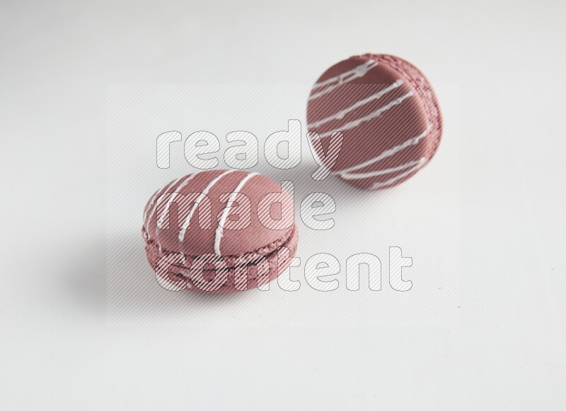 45º Shot of two Red Poppy Flower macarons on white background