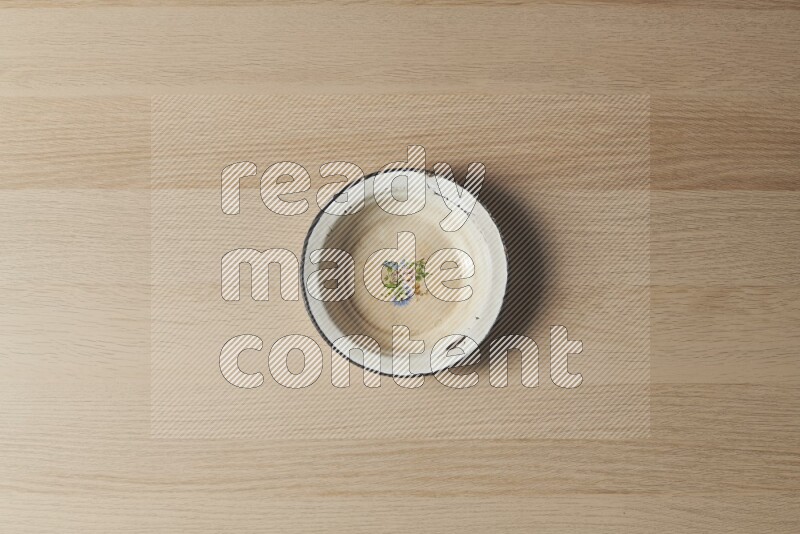 A vintage metal plate on light wooden background