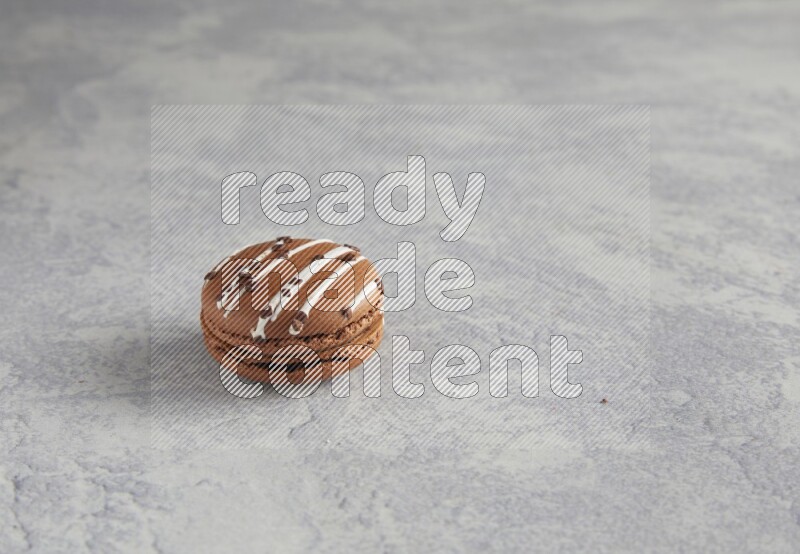 45º Shot of Brown white Chocolate Caramel macaron on white  marble background