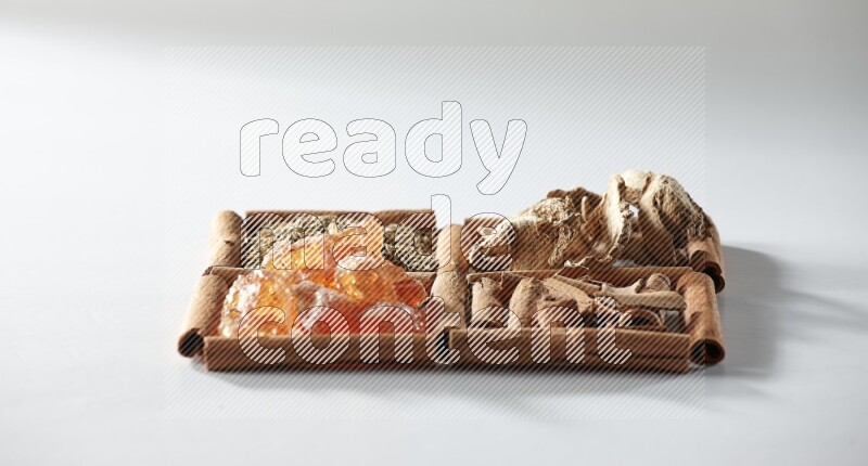 4 squares of cinnamon sticks full of cumin, cinnamon, dried ginger and gum arabic on white flooring