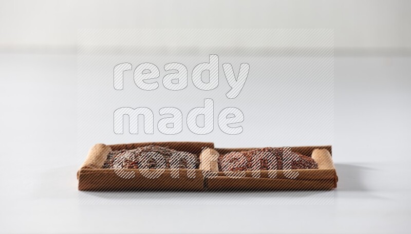 2 squares of cinnamon sticks full of flaxseeds and garden cress on white flooring