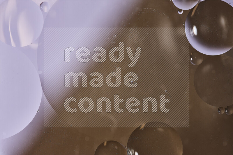 Close-ups of abstract oil bubbles on water surface in shades of white and brown