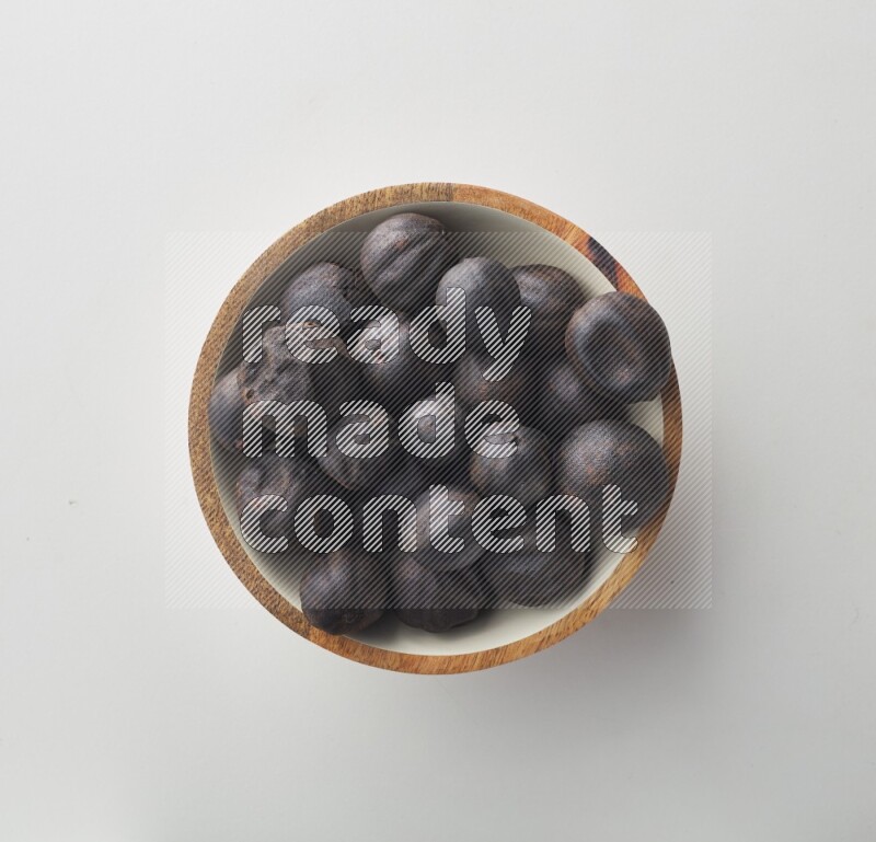 Top-view shot of dried lime (loomi) in a container on white background