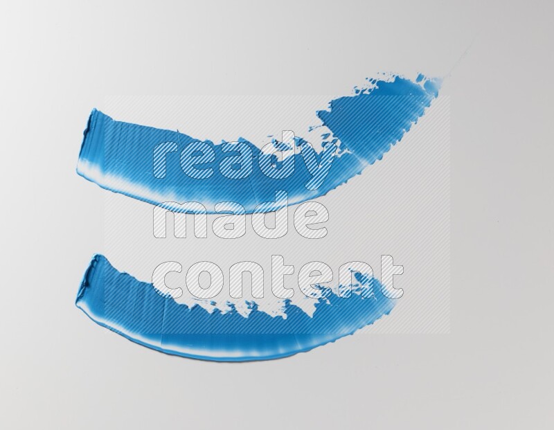Blue curved painting knife strokes on white background
