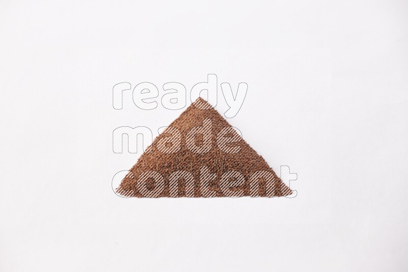 Garden cress seeds in a triangle shape on a white flooring