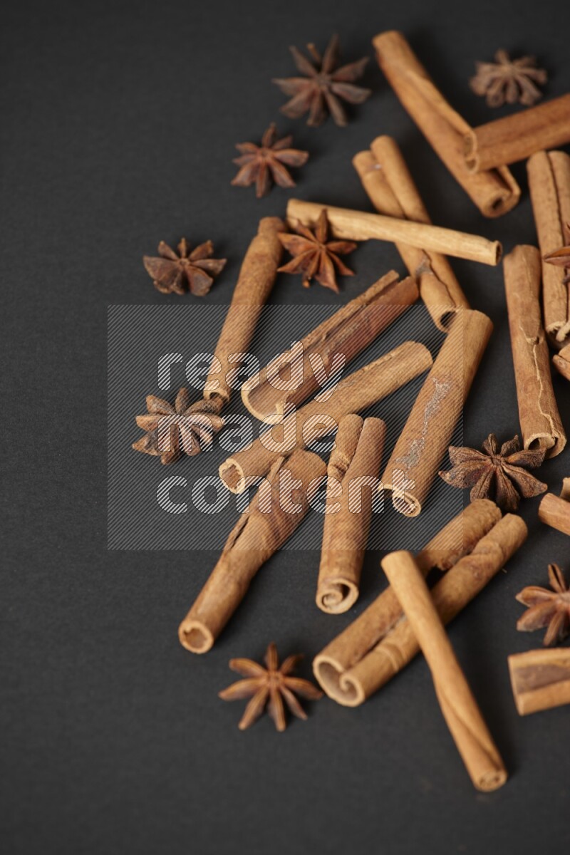 Cinnamon sticks and star anise on black background