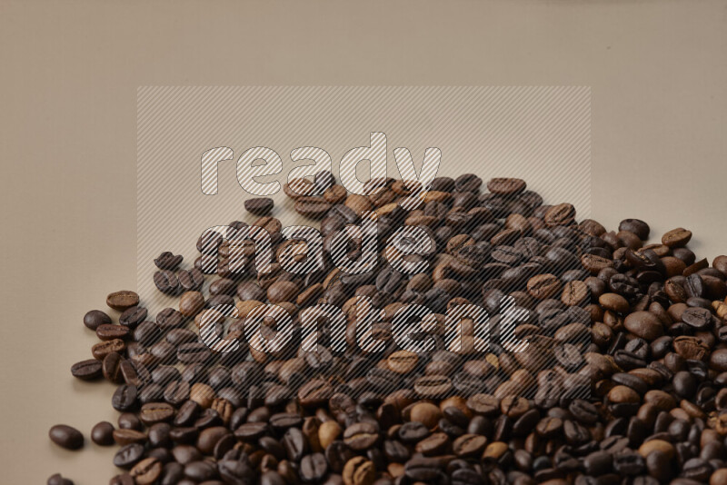 Roasted coffee beans on beige background