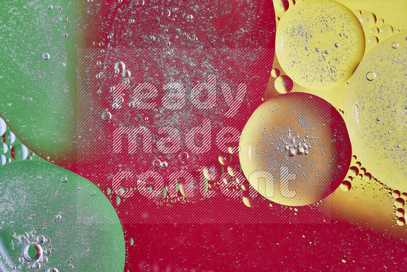 Close-ups of abstract oil bubbles on water surface in shades of yellow, green and red