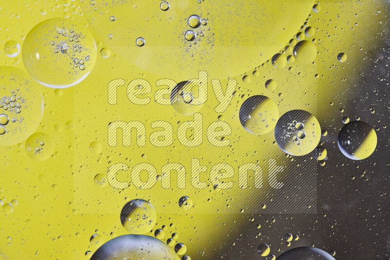 Close-ups of abstract oil bubbles on water surface in shades of yellow and brown