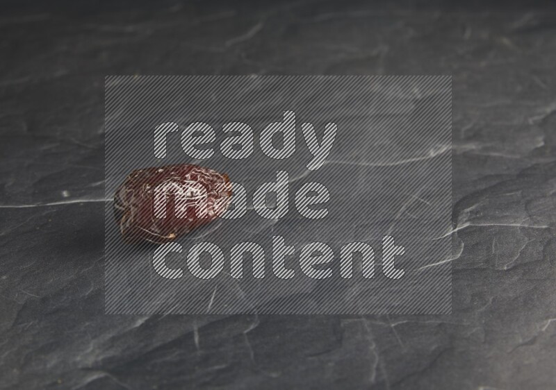 one madjoul date on a black textured background