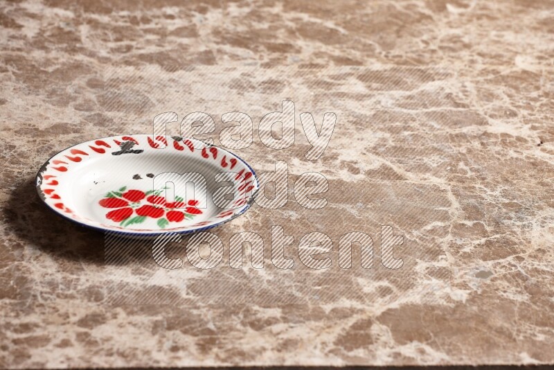 A vintage metal plate on beige marble background