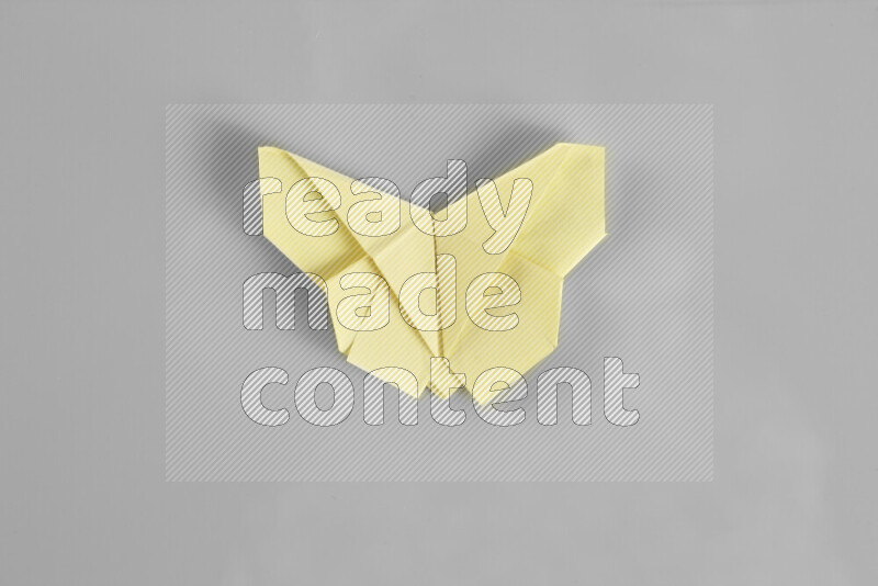 Origami butterfly on grey background