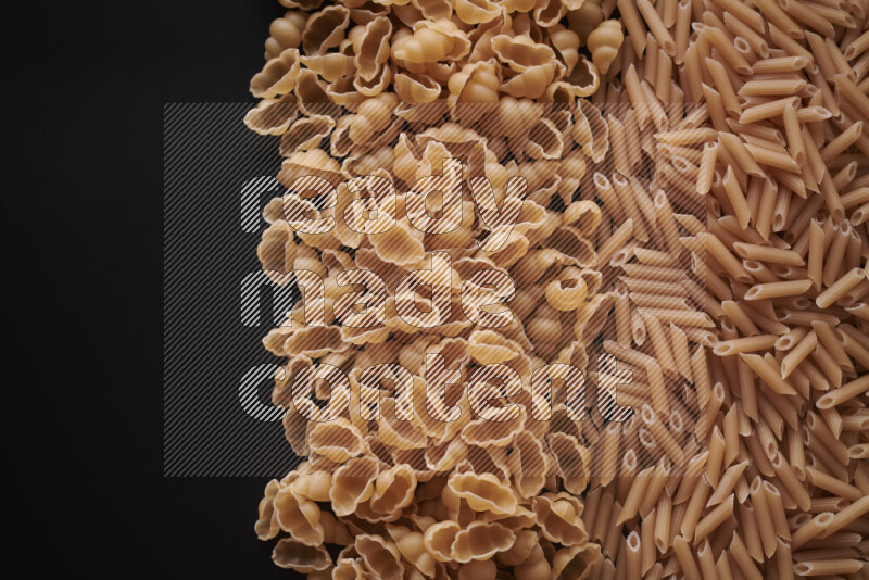 Different pasta types on black background