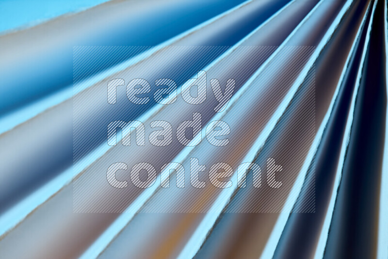 An image presenting an abstract paper pattern of lines in blue and gold tones