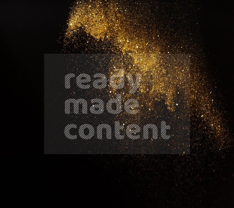 Gold glitter powder isolated on black background