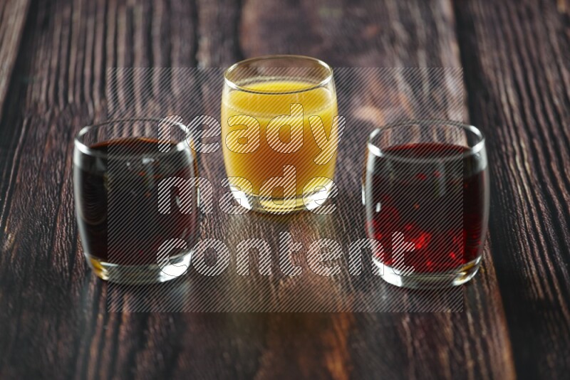 Cold drinks in a glass cup such as water, tamarind, qamar eldin, sobia, milk and hibiscus on wooden background