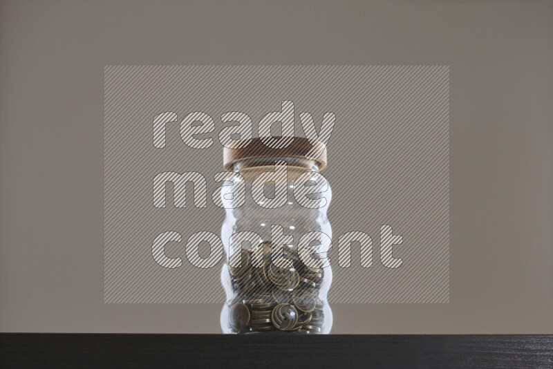 Buttons in a glass jar on black background