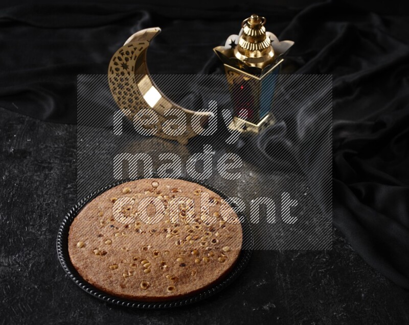 Basbousa with lanterns in a dark setup