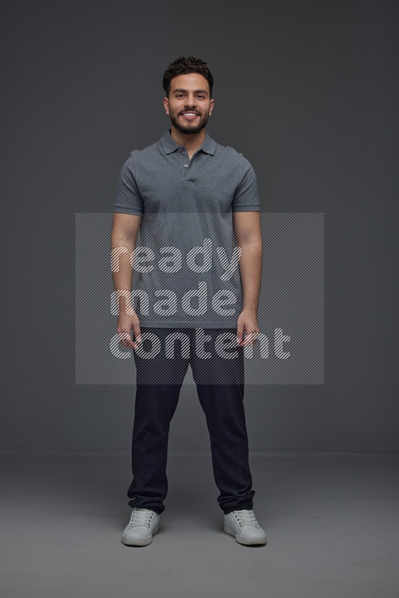 A man wearing casual making multi stand poses  eye level on a gray background