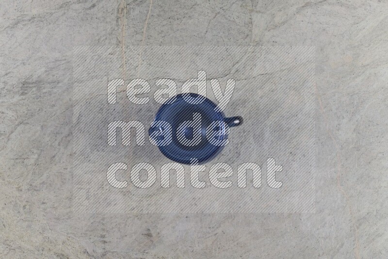 A colored glass jug on grey marble background