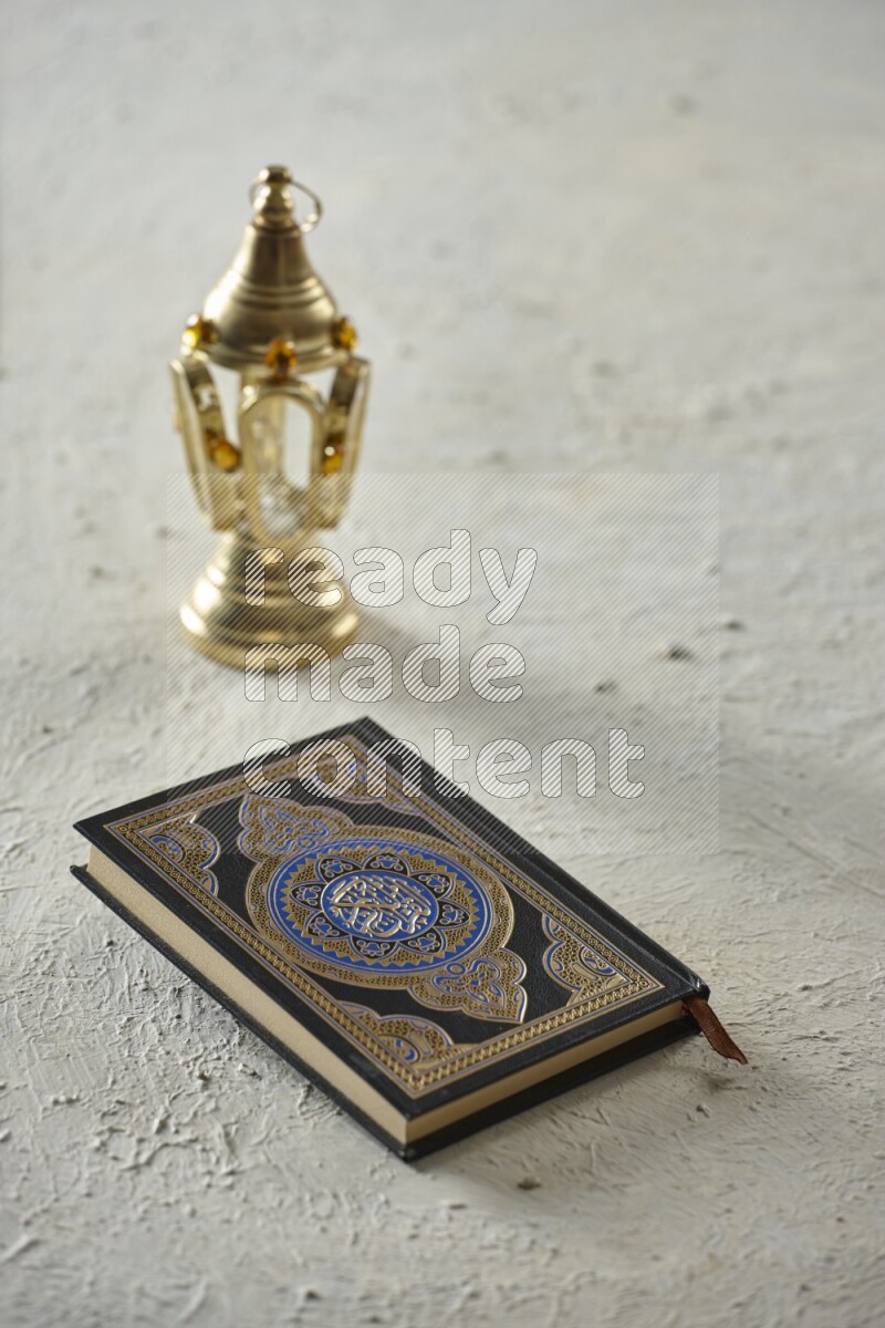 A golden lantern with different drinks, dates, nuts, prayer beads and quran on textured white background
