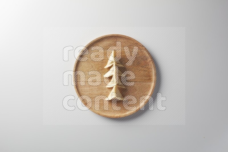 Four Sambosas on a wooden round plate on a white background