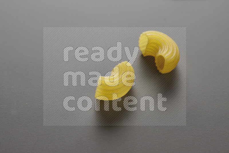 Elbow pasta on grey background