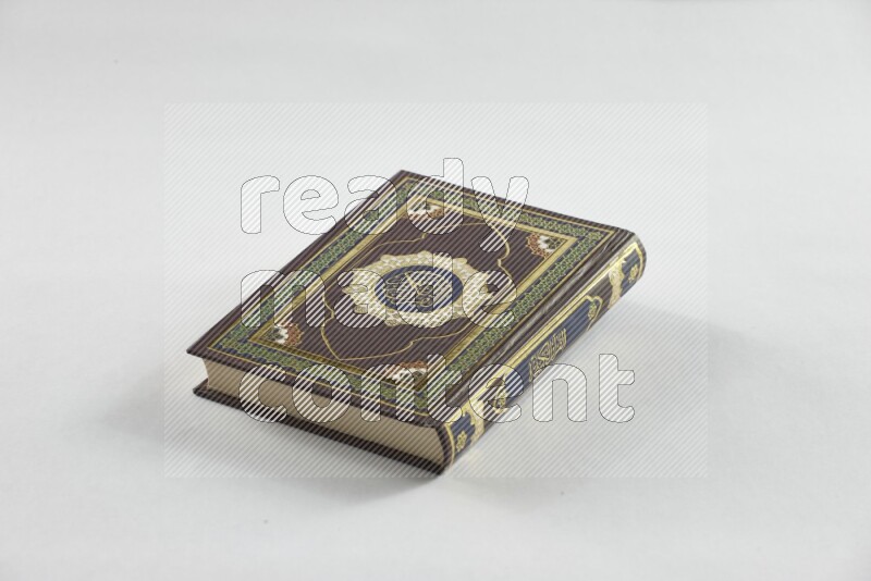 Quran with a prayer beads on white background