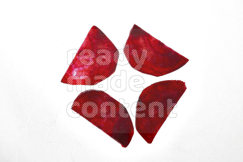 Beet slices on illuminated white background