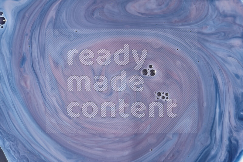 A close-up of abstract swirling patterns in blue, red and white