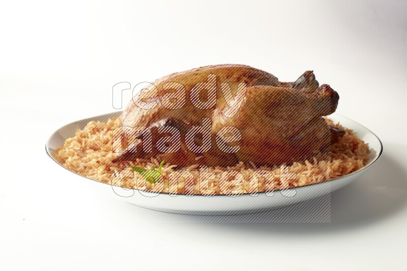 red basmati Rice with whole roasted chicken on a white plate with a silver rim direct on white background
