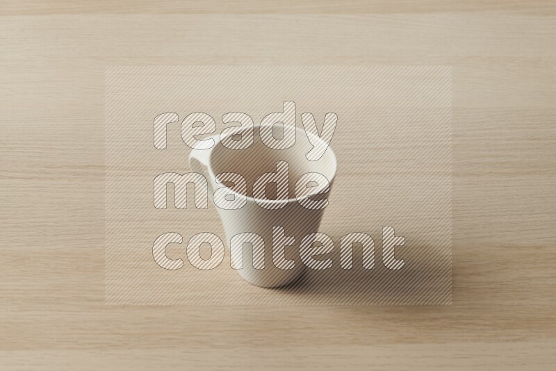 A white ceramic mug on light wooden background