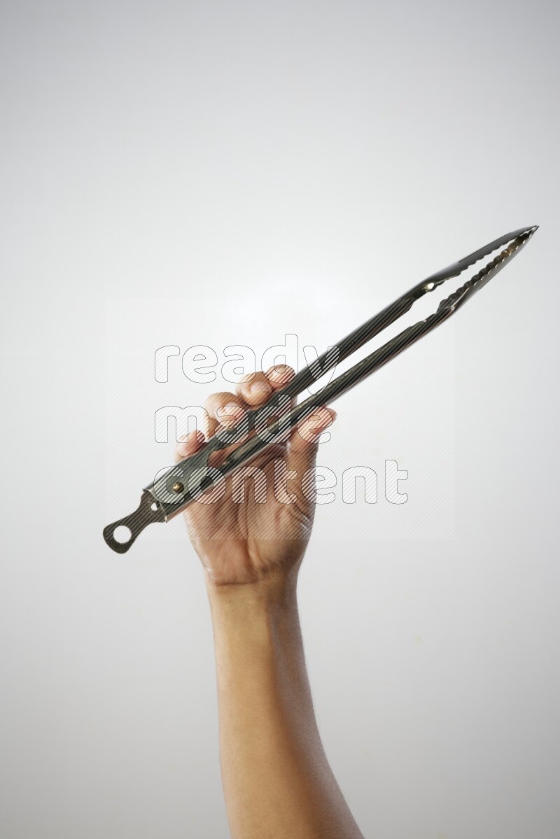 Male Hand Holding Tongs on white background