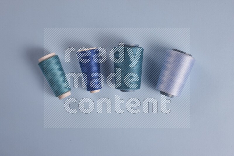 A blue collection of sewing and tailoring tools arranged on a blue background