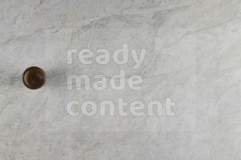 A multicolored pottery Cup on grey marble background