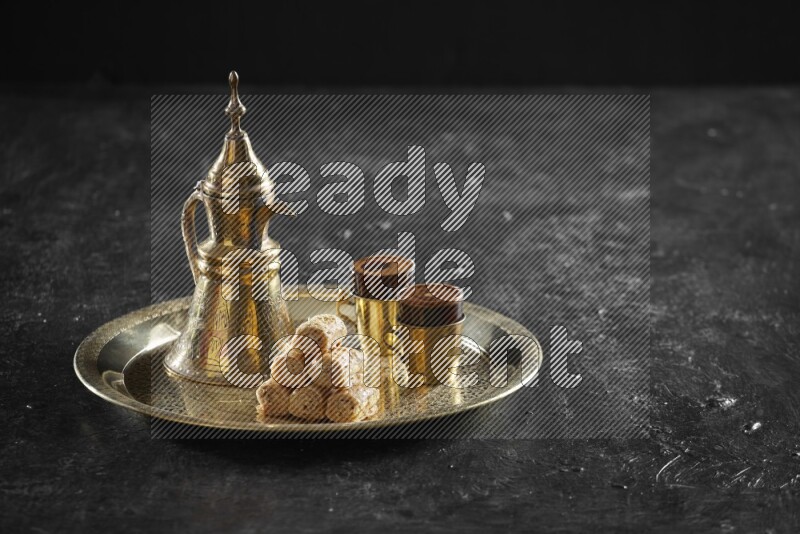 Golash with a drink on a metal tray in a dark setup