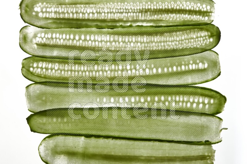 Cucumber slices on illuminated white background