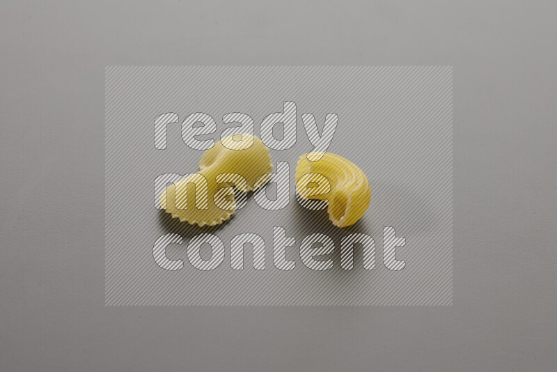 Fiocchi pasta with other types of pasta on grey background