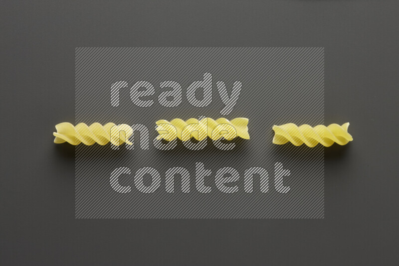 Fusilli pasta on grey background